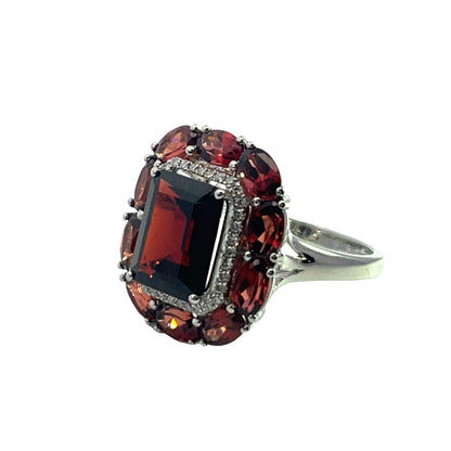 Modern Platinum, diamond and garnet halo ring